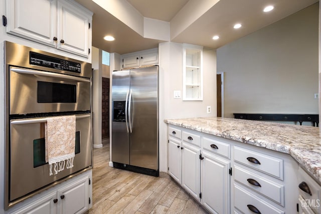 9604 Lea Oak Rd, Bakersfield, CA 93311 - kitchen with appliances with stainless steel finishes, light wood finished floors, white cabinets, recessed lighting, and light stone countertops