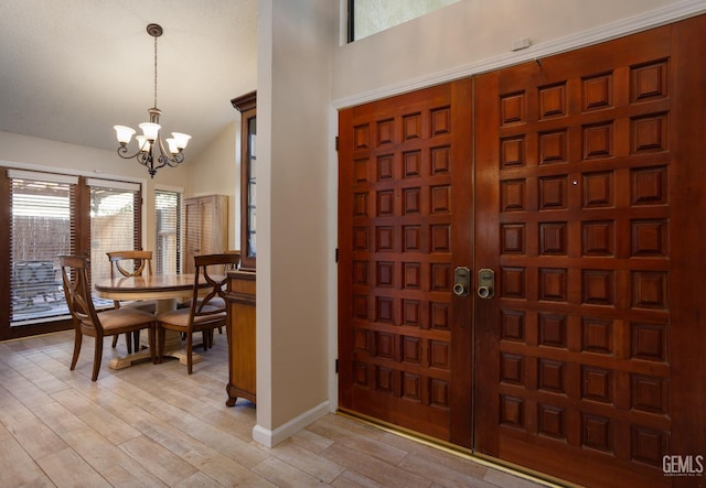 9604 Lea Oak Rd, Bakersfield, CA 93311 - foyer with a chandelier, light wood-style floors, vaulted ceiling, and baseboards