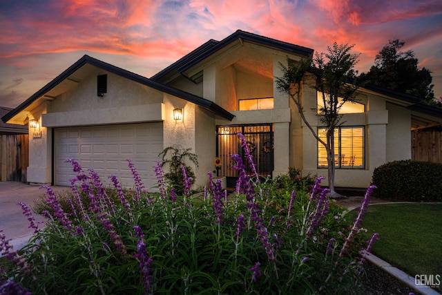 9604 Lea Oak Rd, Bakersfield, CA 93311 - view of front of property with stucco siding, an attached garage, and driveway