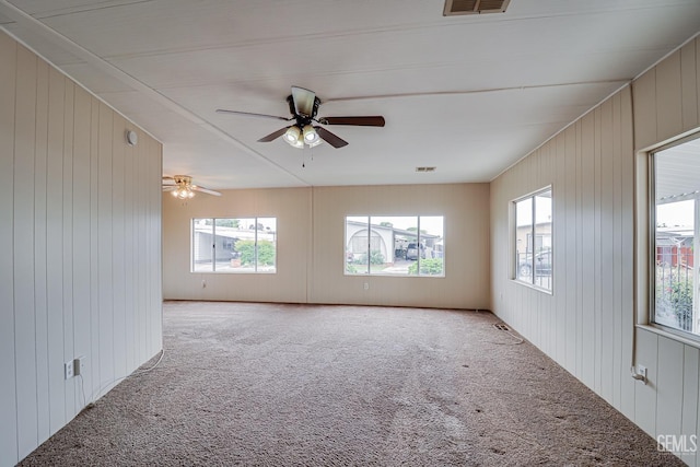 400 E Roberts Ln Unit 48, Bakersfield, CA 93308 - empty room featuring light carpet, plenty of natural light, wooden walls, and ceiling fan