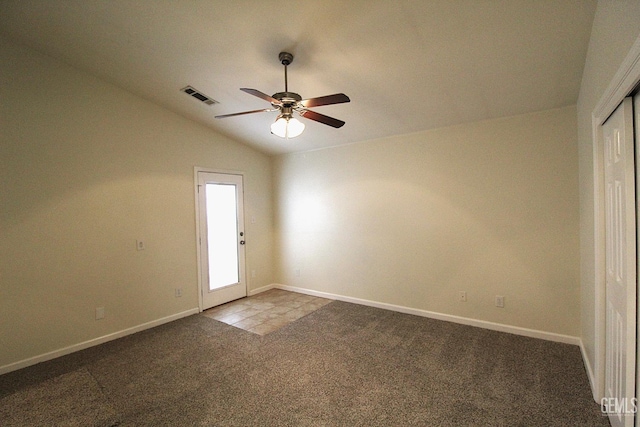 unfurnished room featuring ceiling fan, visible vents, carpet flooring, lofted ceiling, and baseboards