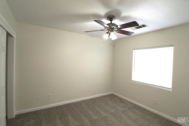 unfurnished bedroom with a closet, baseboards, carpet flooring, a ceiling fan, and visible vents