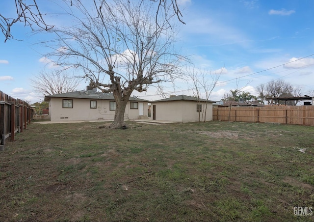 rear view of property featuring a lawn