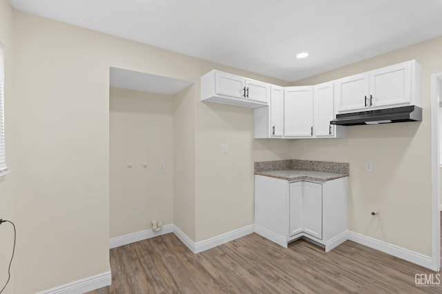 clothes washing area featuring gas dryer hookup and light wood-type flooring