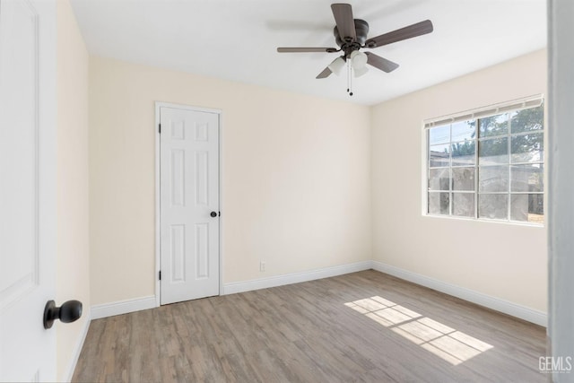 empty room with ceiling fan and light wood-type flooring