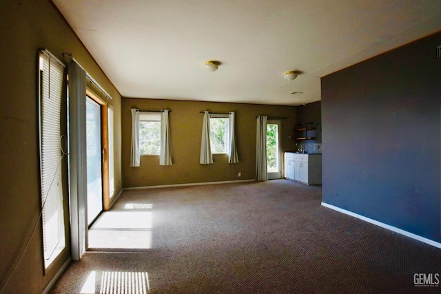 25231 Paramount Dr, Tehachapi, CA 93561 - unfurnished living room featuring plenty of natural light and carpet