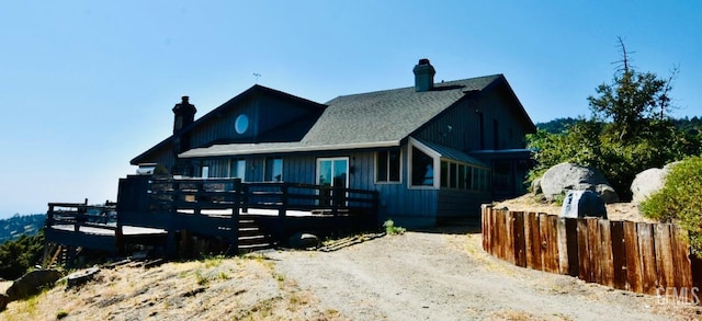 25231 Paramount Dr, Tehachapi, CA 93561 - view of front of property with a chimney, a wooden deck, board and batten siding, and roof with shingles