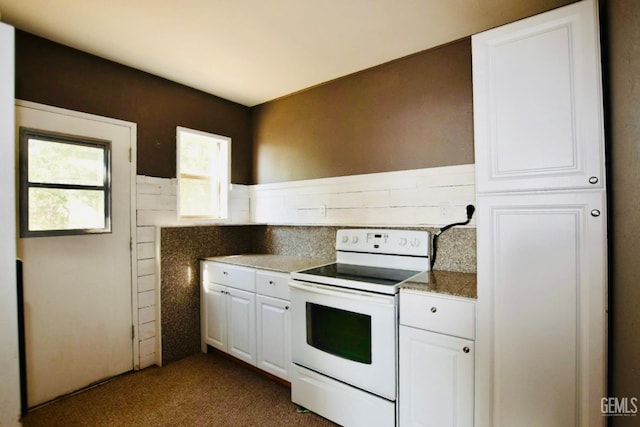 25231 Paramount Dr, Tehachapi, CA 93561 - kitchen with electric stove, white cabinetry, and dark colored carpet