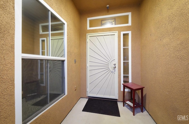 property entrance with stucco siding