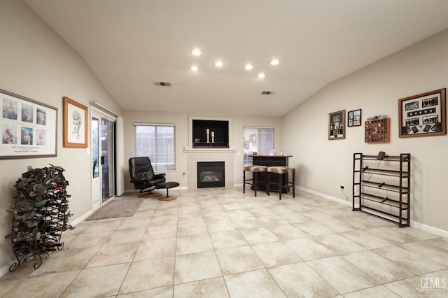 living area with lofted ceiling, visible vents, a fireplace, and recessed lighting