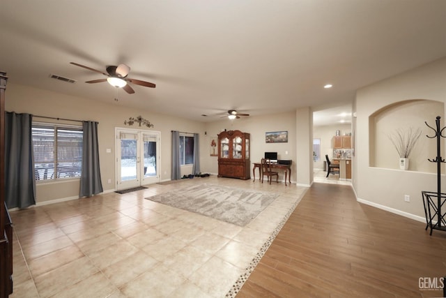 foyer with french doors, wood finished floors, visible vents, and baseboards