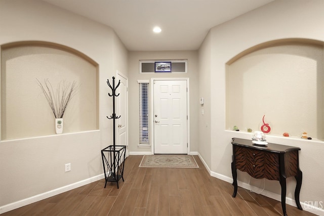 entrance foyer featuring baseboards, wood finished floors, and recessed lighting