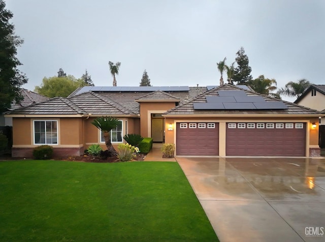 view of front facade with a garage, stucco siding, concrete driveway, and a front yard