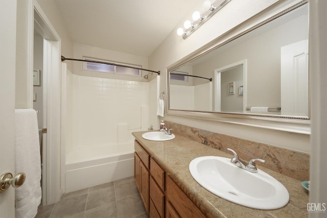 bathroom featuring double vanity, a sink, washtub / shower combination, and tile patterned floors