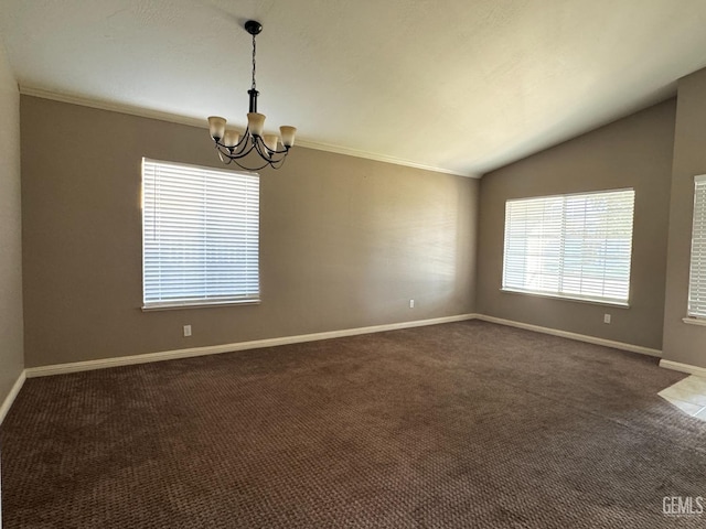 unfurnished room with baseboards, an inviting chandelier, vaulted ceiling, crown molding, and dark carpet