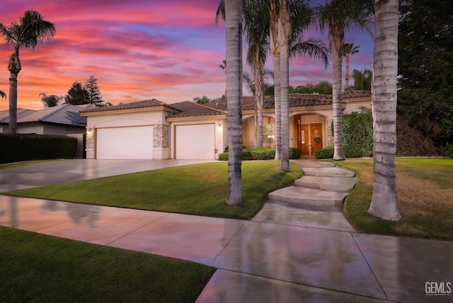 4400 Cron Way, Bakersfield, CA 93311 - mediterranean / spanish home with stucco siding, a garage, driveway, a tile roof, and a yard
