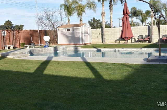 view of pool with a storage shed and a lawn