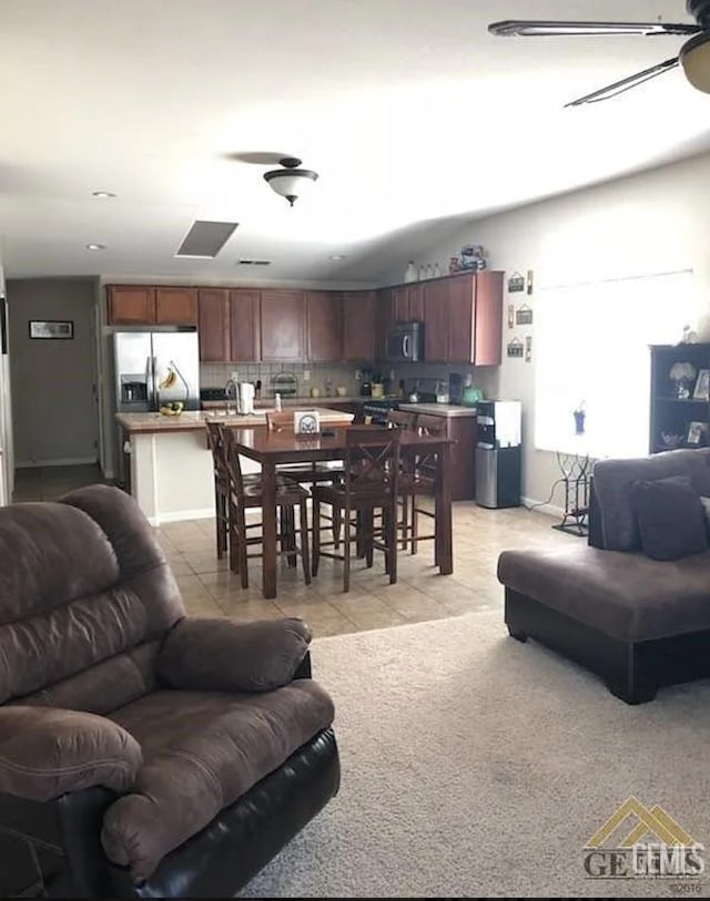 living room with ceiling fan and light tile patterned flooring