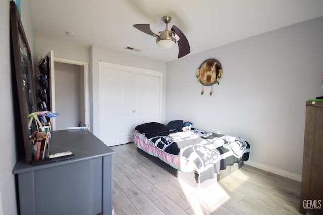 11712 Novara Ave, Bakersfield, CA 93312 - bedroom featuring light wood-style flooring, a closet, a ceiling fan, and baseboards