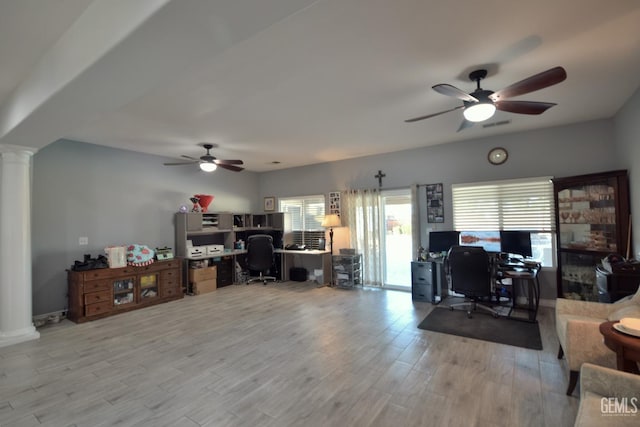 office featuring ceiling fan, light hardwood / wood-style floors, and decorative columns