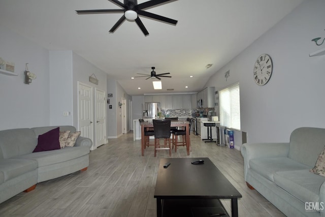 living room featuring ceiling fan and light hardwood / wood-style flooring