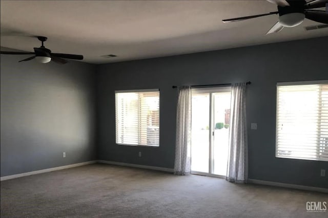 carpeted empty room featuring ceiling fan