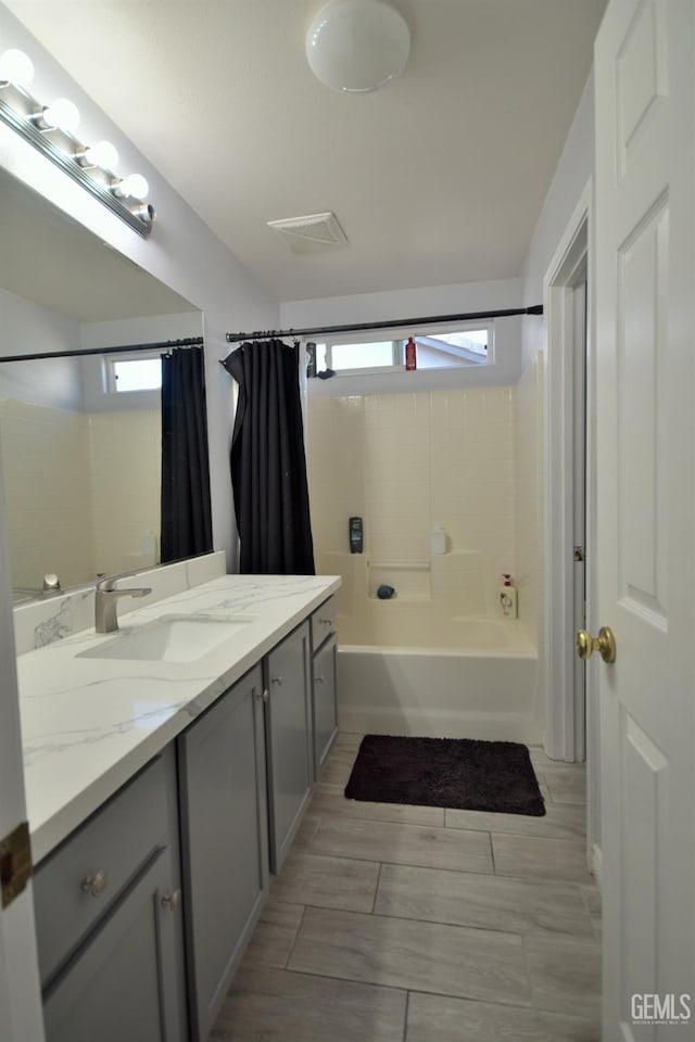 bathroom with shower / bath combination with curtain and vanity