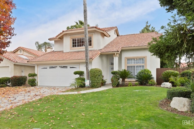 mediterranean / spanish-style house featuring a front yard and a garage