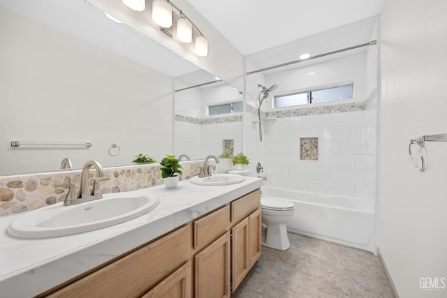 full bathroom with tiled shower / bath combo, vanity, and toilet