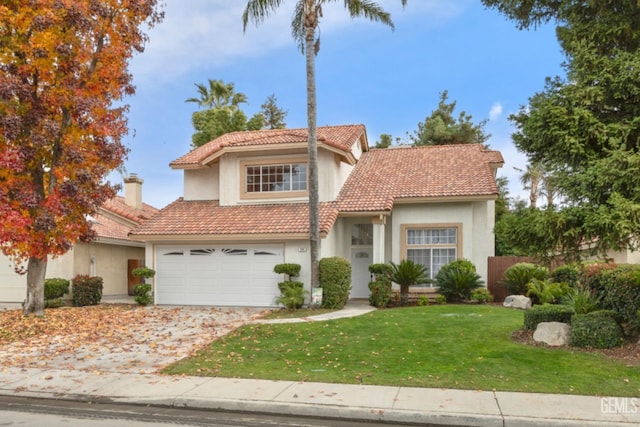 view of front of property with a garage and a front lawn