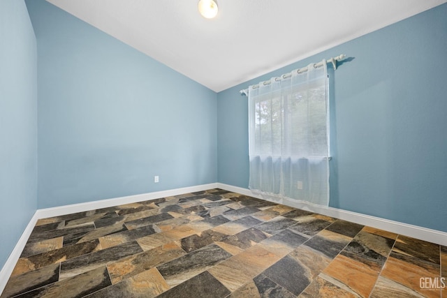 spare room with lofted ceiling