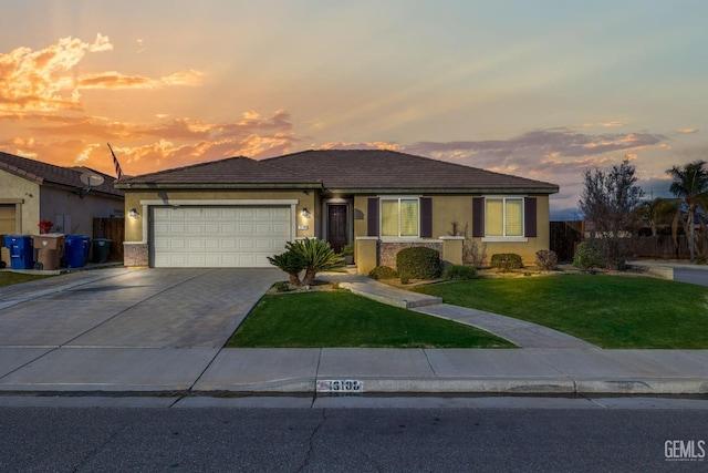 single story home featuring a yard and a garage