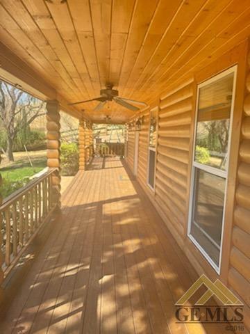 wooden deck with ceiling fan and a porch