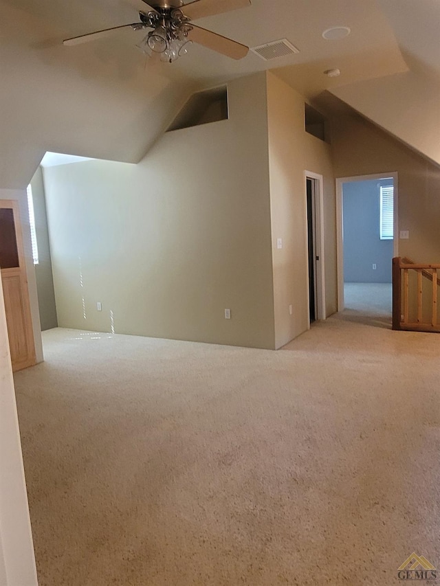 bonus room with ceiling fan, light colored carpet, and vaulted ceiling