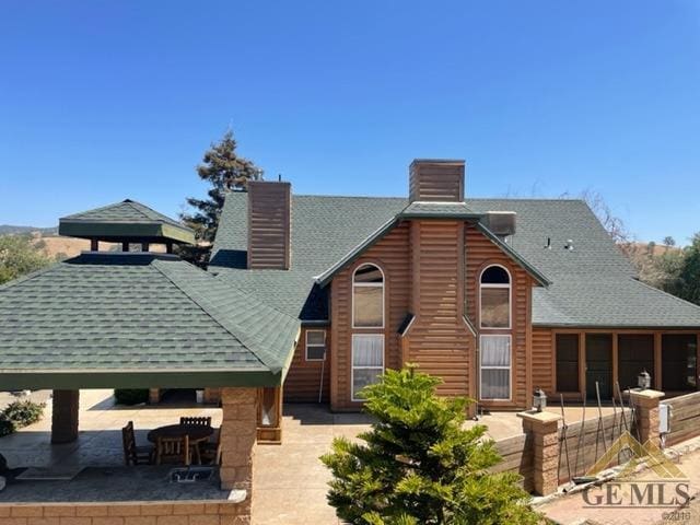 rear view of house with a gazebo and a patio area