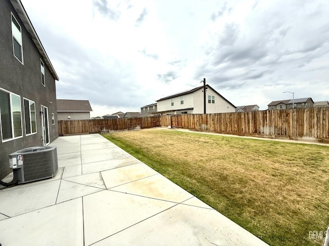 view of yard featuring central air condition unit and a patio area
