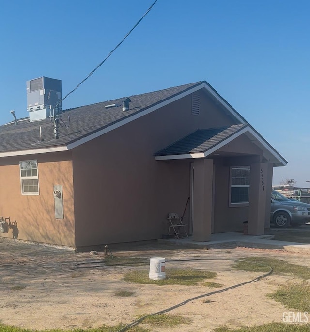 back of property featuring cooling unit