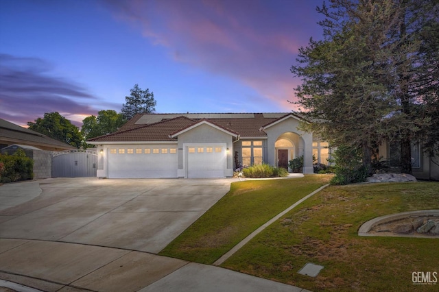 4504 Polo Club Dr, Bakersfield, CA 93312 - view of front of house featuring a gate, a garage, stucco siding, concrete driveway, and a front lawn