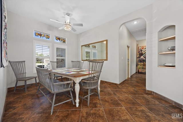 4504 Polo Club Dr, Bakersfield, CA 93312 - dining space with ceiling fan, built in shelves, and arched walkways