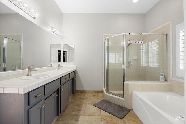 4504 Polo Club Dr, Bakersfield, CA 93312 - bathroom featuring a garden tub, double vanity, a shower stall, and tile patterned floors
