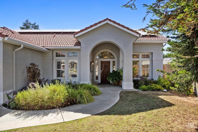 4504 Polo Club Dr, Bakersfield, CA 93312 - entrance to property featuring a tile roof, stucco siding, and roof mounted solar panels