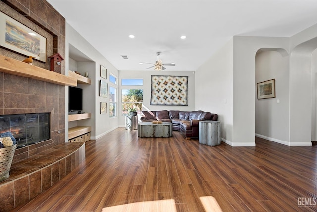 4504 Polo Club Dr, Bakersfield, CA 93312 - living area featuring a ceiling fan, dark wood finished floors, recessed lighting, arched walkways, and a fireplace
