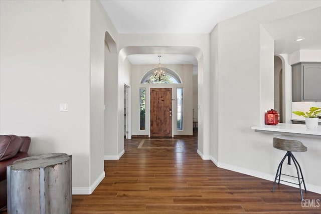 4504 Polo Club Dr, Bakersfield, CA 93312 - foyer entrance featuring a chandelier, arched walkways, and wood finished floors