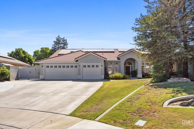 4504 Polo Club Dr, Bakersfield, CA 93312 - mediterranean / spanish home featuring a gate, stucco siding, a garage, a tiled roof, and a front yard