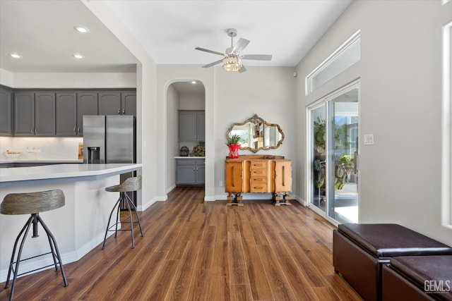4504 Polo Club Dr, Bakersfield, CA 93312 - kitchen featuring a breakfast bar, stainless steel refrigerator with ice dispenser, gray cabinetry, light countertops, and recessed lighting
