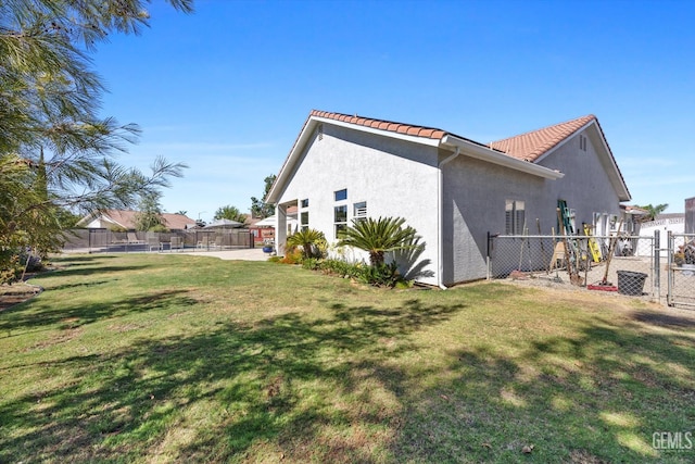 4504 Polo Club Dr, Bakersfield, CA 93312 - view of side of home with a tiled roof and stucco siding