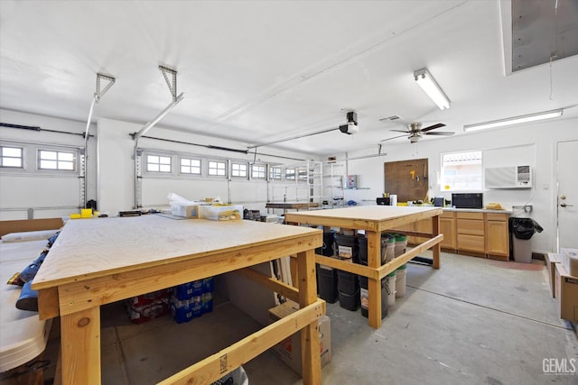 4504 Polo Club Dr, Bakersfield, CA 93312 - garage with a wall mounted AC, a workshop area, and a ceiling fan