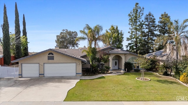 view of front of property featuring a garage, driveway, a front lawn, and stucco siding