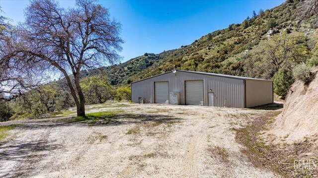 detached garage featuring a mountain view