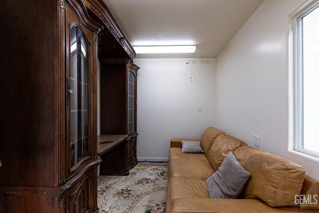 living area featuring baseboards